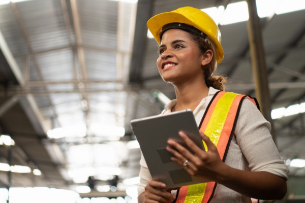 Woman smiling holding a  tablet.